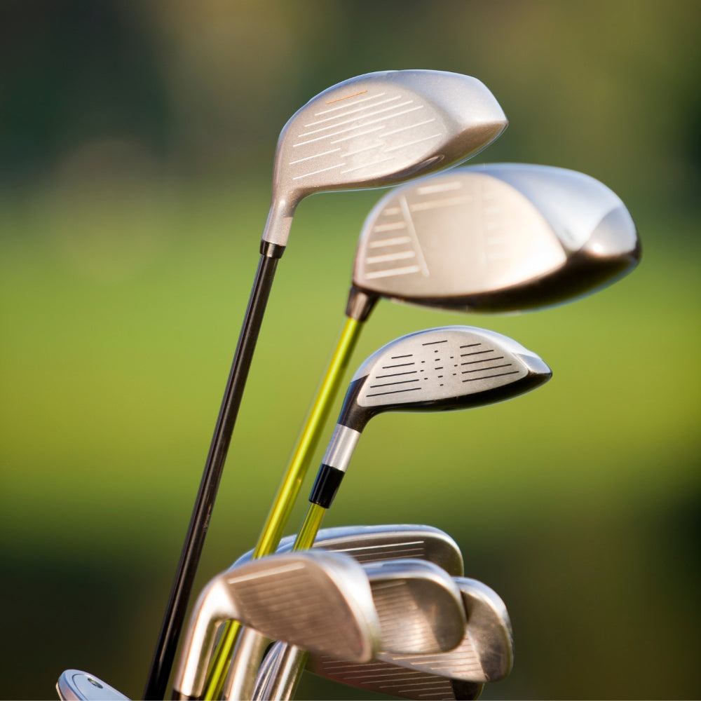 Selection of golf clubs standing upright, showcasing their sleek designs.